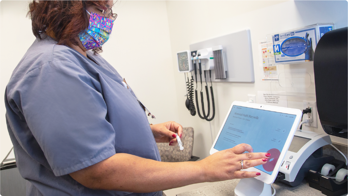 A nurse uses the VaxCare Hub to automatically record the details of a vaccination.