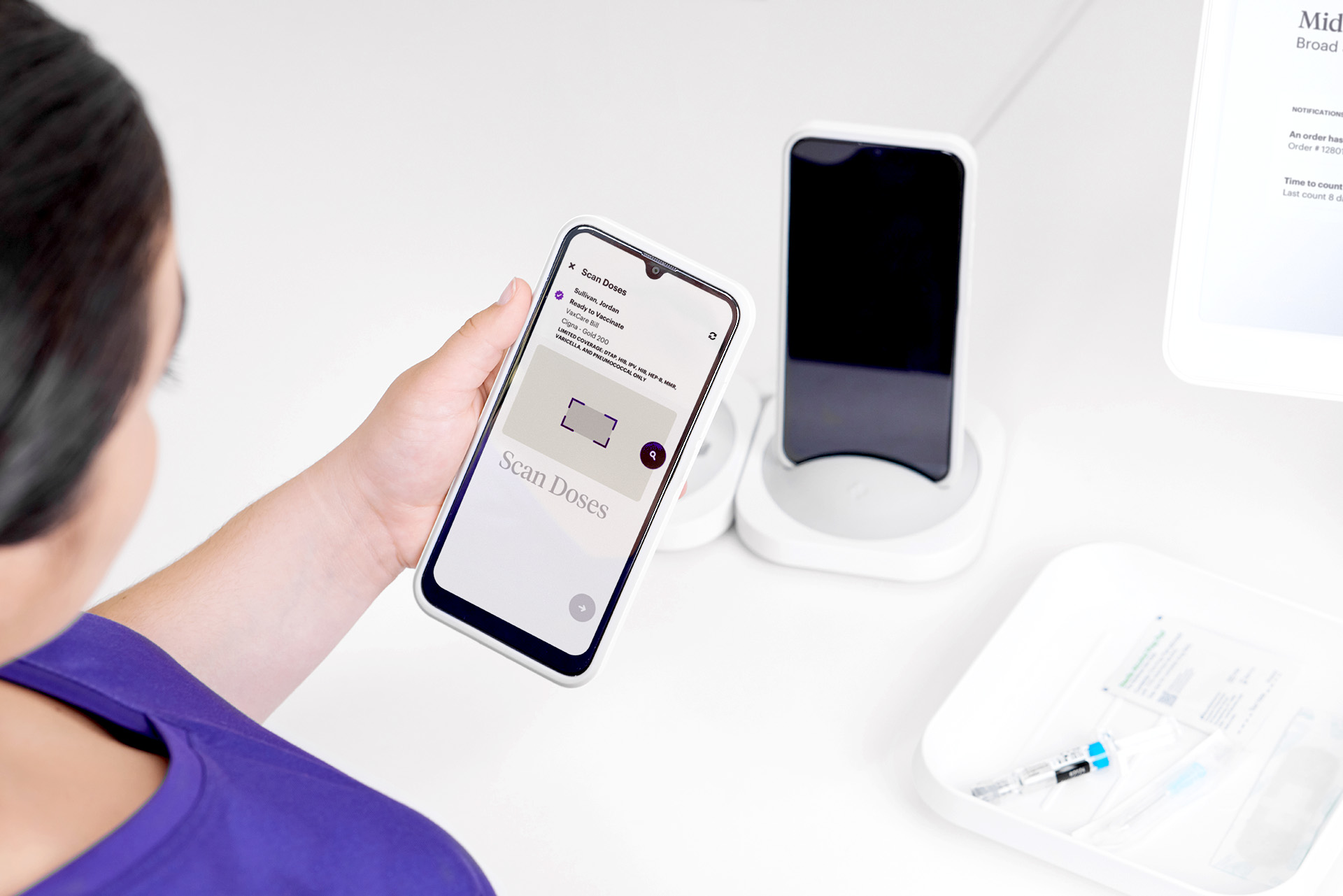 A nurse uses the VaxCare Mobile Hub to scan a dose for automatic vaccine eligibility.
