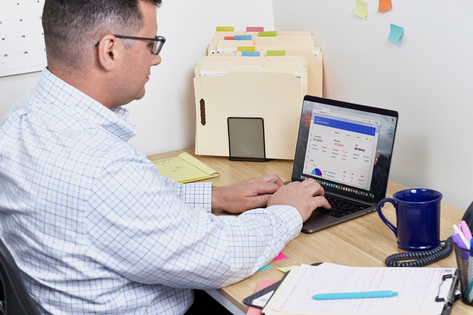 An office manager reviews the financial results of VaxCare's automatic vaccine billing.