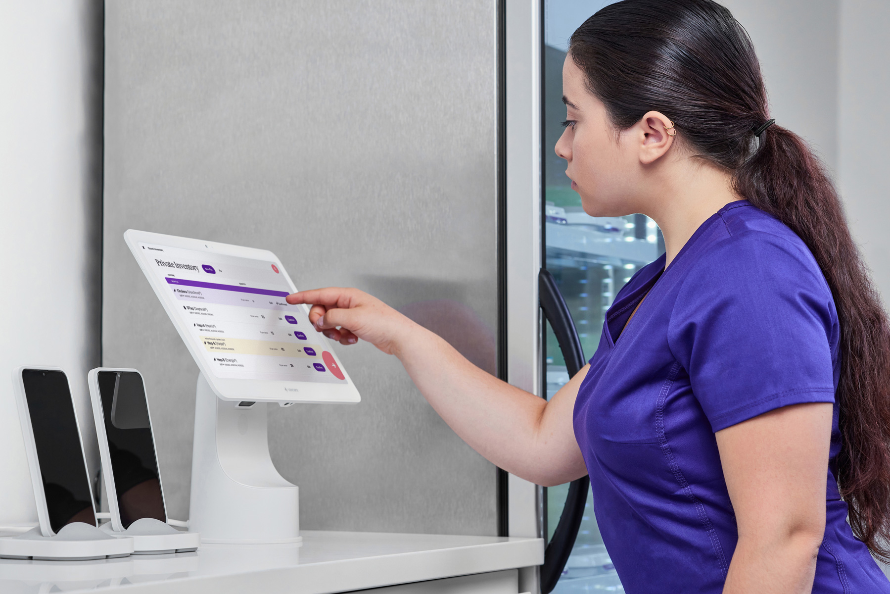 A nurse uses the VaxCare Hub to verify the accuracy of their automatic vaccine management.